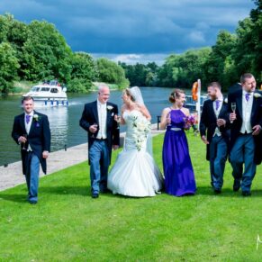 Oakley Court wedding photography of the bridal party going for a walk along the river