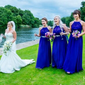 Oakley Court wedding photography of the bridal party taking a stroll beside the river