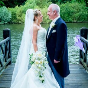 Oakley Court wedding photography of the newlyweds on the jetty with the River Thames behind