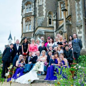 Oakley Court wedding photography of a large group on the steps overlooking the river