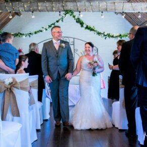 The newlyweds exit the ceremony at their Five Arrows Hotel wedding