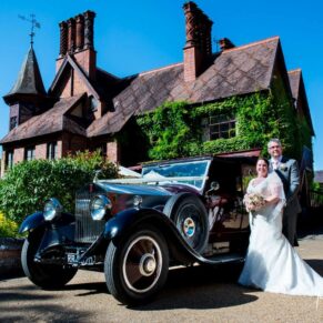 The newlyweds with their car at Five Arrows Hotel wedding