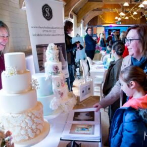 Visitors viewing a display stand at the Waddesdon Wedding Inspiration Day