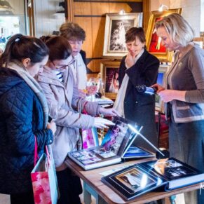 Vistors viewing Mark Sisley's photograph albums at the Waddesdon Wedding Inspiration Day