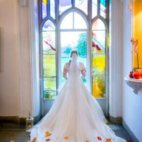 Missenden Abbey autumn wedding shot of the bride in the stained glass window