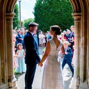 Newlyweds in the doorway at their St Mary's Church Amersham wedding