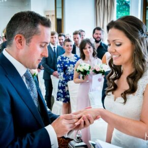 Exchanging rings at Taplow House summer wedding