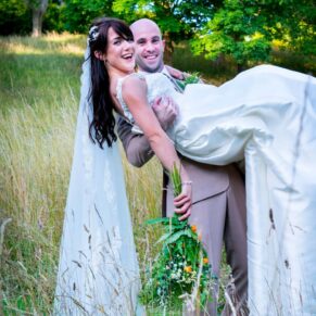 Dairy Waddesdon wedding photographs of the bride being lifted by her husband
