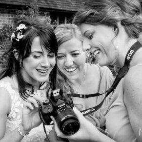 Dairy Waddesdon wedding photographs of the bride checking out the images on her friend's camera
