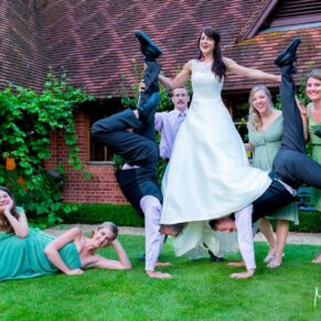Dairy Waddesdon wedding photographs of the bride and her guests striking a pose with the acrobats