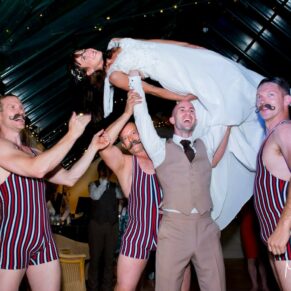 Dairy Waddesdon wedding photographs of the bride being lifted by the acrobats