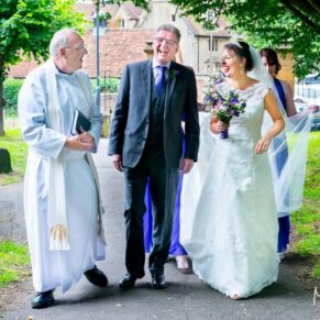 Wedding at St Mary's Church Thame - walking towards the ceremony with the vicar