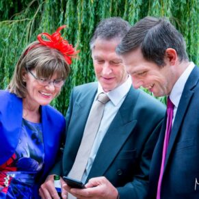 Waddesdon wedding photography of guests watching the football scores