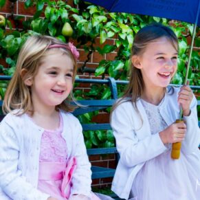 Waddesdon wedding photography of these young ladies sheltering from the rain