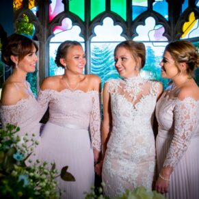 Missenden Abbey wedding of the ladies enjoying a chat with a feature window behind