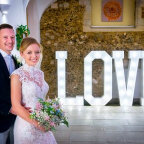 Missenden Abbey wedding image captured of the newlyweds with their giant illuminated letters