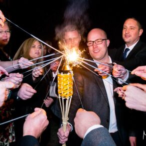 Lighting the sparklers at this Dairy, Waddesdon Christmas wedding