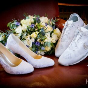 Dairy Waddesdon Spring wedding image of the bride's trainers, posh shoes and her bouquet