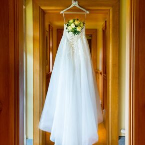 The gown hanging up before this Waddesdon Dairy Christmas wedding ceremony