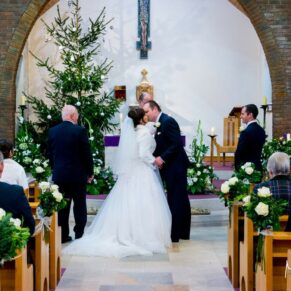 The first kiss at St Josephs Church wedding in Thame