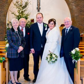 Group pose at St Josephs Church wedding in Thame