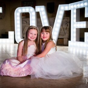 Waddesdon Dairy Christmas wedding pose by the giant illuminated letters