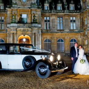 Waddesdon Dairy Christmas wedding pose with the car at the manor after dusk