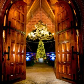 Waddesdon Dairy Christmas wedding image catured through the entrance doorway