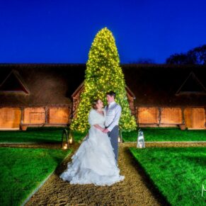 Dairy Waddesdon wedding pose by the Christmas tree in the courtyard