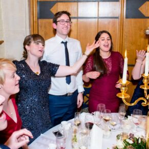 The guests singing their hearts out at Dairy Waddesdon Christmas wedding