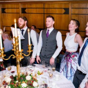 The guests join in with the singing at Dairy Waddesdon Christmas wedding