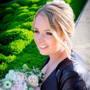 Waddesdon Manor photography shoot of the bride wearing a leather jacket over her gown