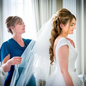 Hedsor House wedding photographs of mum adjusting her daughter's veil before the ceremony