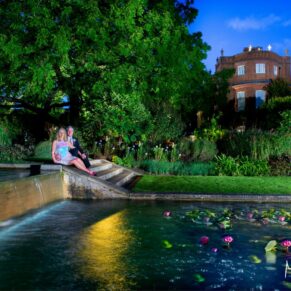 Grove Hotel Watford wedding photography of the bride and groom sat by the waterfall