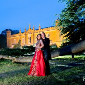 Missenden Abbey wedding blog featuring Alpana & Martin - Floodlit pose at dusk by the cedar tree