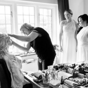 Black and white image of bridesmaids getting ready at Notley Tythe Barn wedding