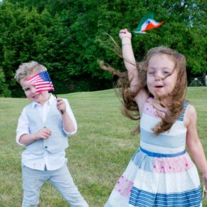 Notley Tythe Barn wedding children playing with flags