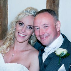 Notley Tythe Barn wedding newlyweds pose for the camera on their special day