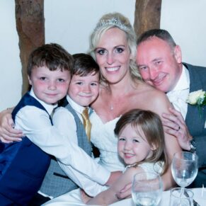 Notley Tythe Barn wedding group hug with the kids