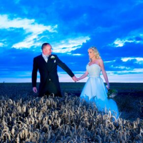 Notley Tythe Barn wedding in the wheat field at dusk