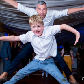 Star jumps from these young men at Notley Tythe Barn wedding