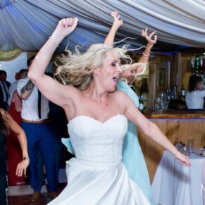 The bride dancing at her Notley Tythe Barn wedding reception