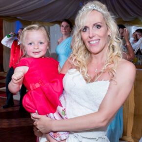 Bride and young guest at her Notley Tythe Barn wedding