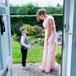 Bridesmaid chatting with young usher at Notley Tythe Barn wedding