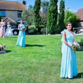 Bridesmaids on lawn at Notley Tythe Barn wedding