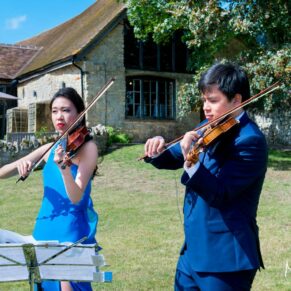 Guests in the sunshine at Notley Tythe Barn wedding