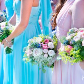 Beautiful image of pastel bridesmaid dresses and flowers at Notley Tythe Barn wedding