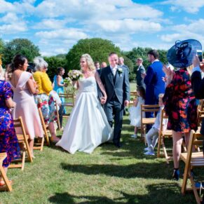 Bride and groom on the lawn at Notley Tythe Barn wedding