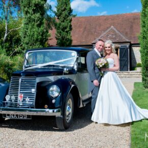 Bride and groom and wedding car at Notley Tythe Barn wedding
