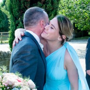Bridesmaid and guest hugging at Notley Tythe Barn wedding